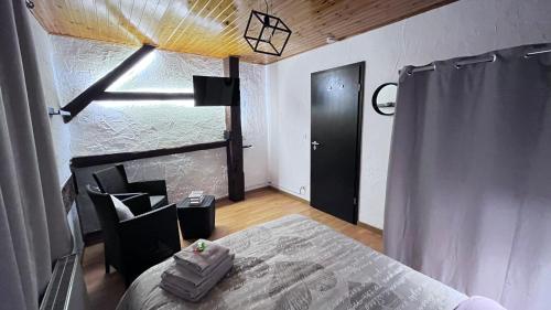 a bedroom with a bed and a black door at Chez Béné in Rochefort
