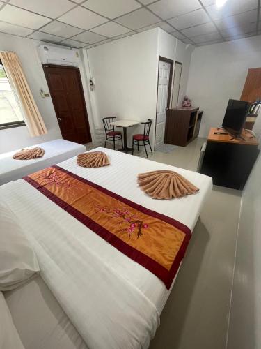 a room with a bed and a table with chairs at JJ karon beach hotel in Karon Beach
