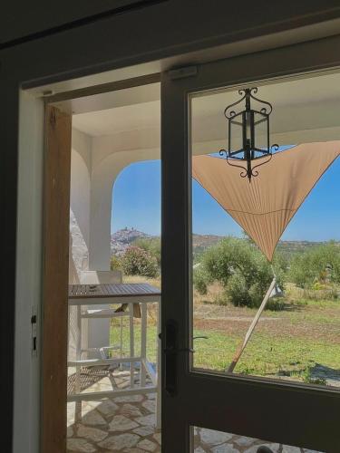 a glass door with a view of a patio at bungalow entre mer et montagne in Arcos de la Frontera