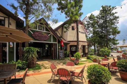 a group of tables and chairs in front of a building at Insta-Worthy Swiss House Staycation Crosswinds Tagaytay in Tagaytay