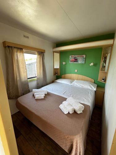 a bedroom with a bed with towels on it at Casa vacanze Trinacria in Menfi