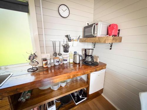 a kitchen with a wooden counter with a microwave at Áshamrar in Hella