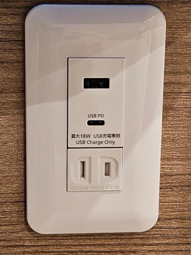 a white electrical outlet on a wooden table at Asakusa Stay in Tokyo