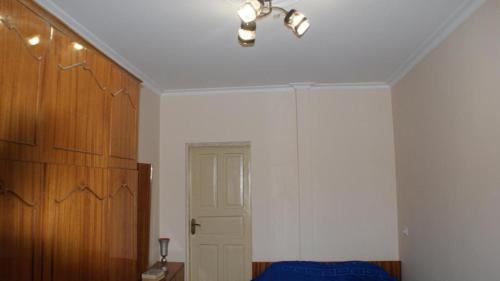 a bedroom with a white wall and a white door at Guest white house with Terrace in Tskaltubo