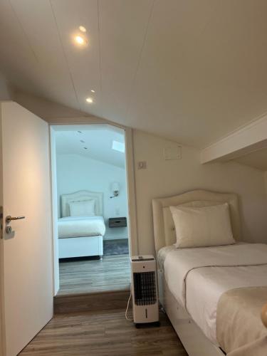 a bedroom with two beds and a room with a bed sqor at AppartHôtel Elite Spa in Forbach