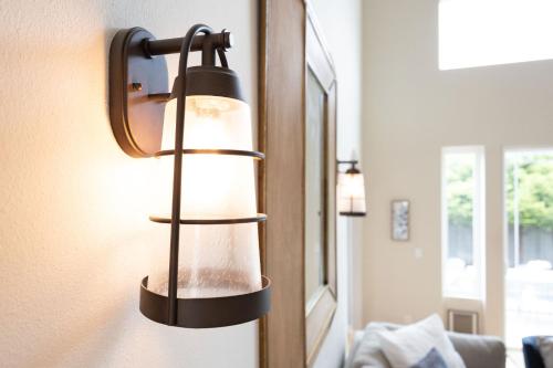 a lamp hanging on a wall next to a mirror at Coastal Dream - 2 Blocks to ocean, steps to beach, hot tub, coastal trail, BBQ in Half Moon Bay