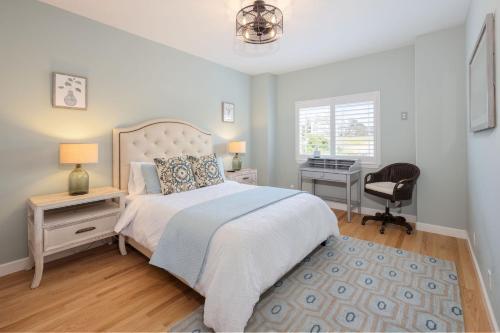 a bedroom with a bed and a desk and a chair at Coastal Dream - 2 Blocks to ocean, steps to beach, hot tub, coastal trail, BBQ in Half Moon Bay