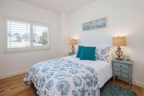 a bedroom with a bed and a window at Coastal Dream - 2 Blocks to ocean, steps to beach, hot tub, coastal trail, BBQ in Half Moon Bay