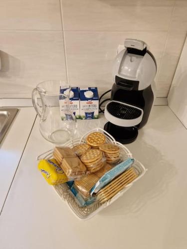 a container of food and a coffee maker on a counter at Villa Castaldi Firenze vicina al centro in Florence