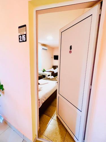 a room with a door leading to a bedroom at MarNar Hotel in Yerevan