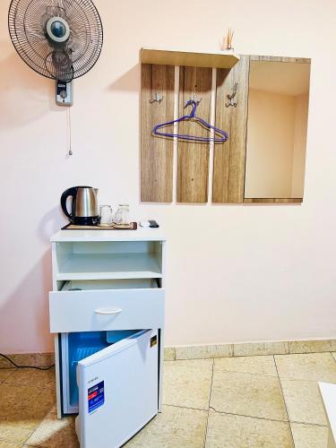 a kitchen with blue and white counters and a fan at MarNar Hotel in Yerevan