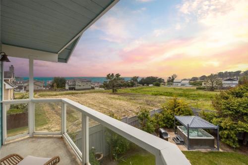 a balcony view of the ocean from a house at Coastal Dream - 2 Blocks to ocean, steps to beach, hot tub, coastal trail, BBQ in Half Moon Bay