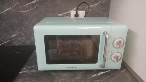 a white toaster oven sitting on top of a counter at Donna di Coppe Apartment in Torre Boldone