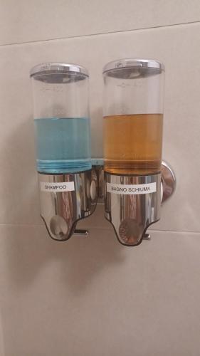 a coffee maker with two cups on a wall at Donna di Coppe Apartment in Torre Boldone