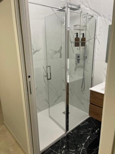a shower with a glass door in a bathroom at Therma Luxury house in Termoli