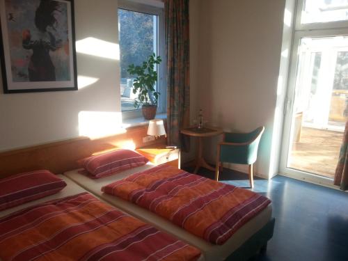 a hotel room with two beds and a window at Hotel zur Sportsbar in Horn-Bad Meinberg