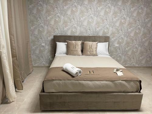 a bedroom with a bed with a footboard and a wall at Therma Luxury house in Termoli