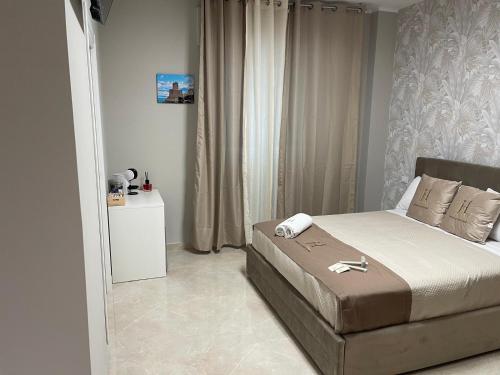 a bedroom with a bed in a room with curtains at Therma Luxury house in Termoli
