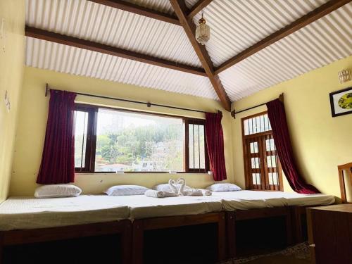 a large bed in a room with a window at Trial Based Hotel in Coonoor
