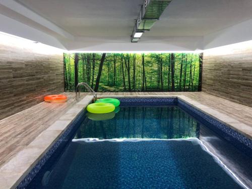 a indoor swimming pool with a tub and a swimming pool at Sabaduri Hills in Tsʼkhvarichamia