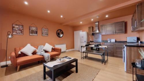 a living room with a couch and a table at Birmingham City Stays Apartments in Birmingham