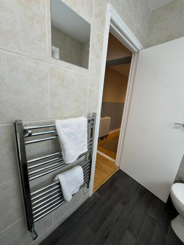 a bathroom with a towel rack and a toilet at Birmingham City Stays Apartments in Birmingham