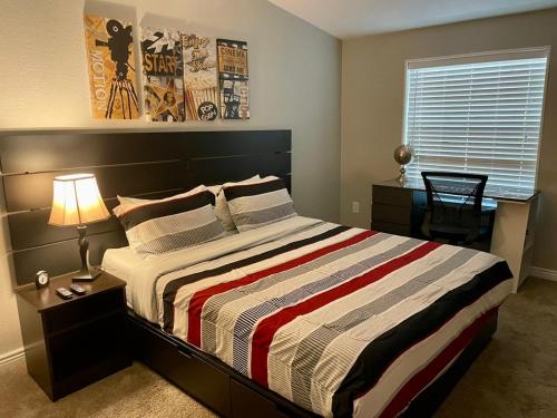 a bedroom with a large bed with a striped blanket at Sedona Red Rock Garden of Paradise Pets friendly and Hot tub in Sedona