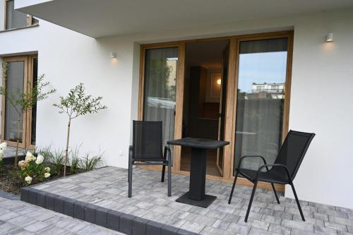 two chairs and a table in front of a house at Port Rewa in Rewa