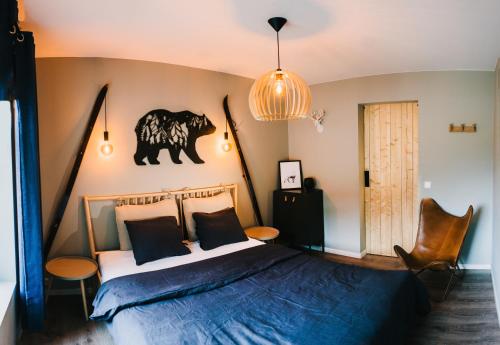 a bedroom with a bed with a black and white comforter at Frafjord Apartments Thor in Dirdal