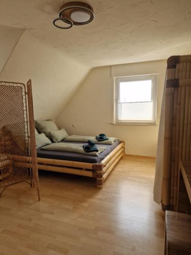 a bedroom with a bed and a window at Ferienwohnung an der Limburg in Weilheim an der Teck