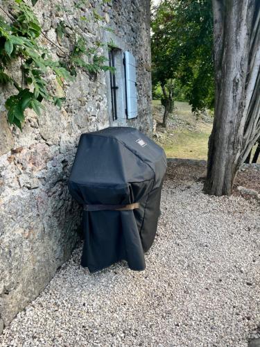 a black duffle bag sitting next to a building at Magnifique Mas Cevenol in Anduze