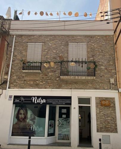 a building with a sign on the side of it at Tutu llar ús turistic in Amposta