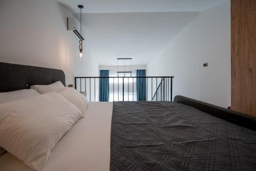 1 dormitorio con cama blanca y cabecero negro en Appartement en Chêne, en Kotor