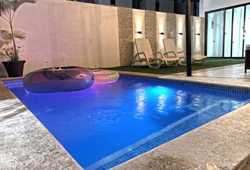 a swimming pool with a purple object in the water at Private pool villa with jacuzzi, near beaches in Punta Cana