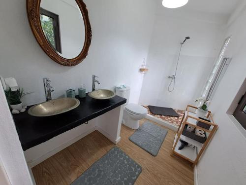 a bathroom with two sinks and a mirror at Pool House au cœur du Gérès à Rio Caldo in Rio Caldo
