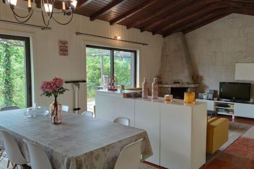 a kitchen and dining room with a table and chairs at Pool House au cœur du Gérès à Rio Caldo in Rio Caldo