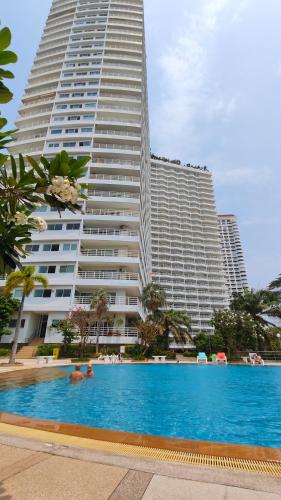 a large building with a swimming pool in front of a building at Super View in Pattaya South