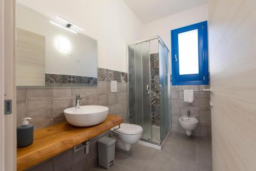a bathroom with a sink and a toilet and a shower at Bed and Breakfast Da Francesca in Castelluzzo