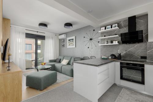 a kitchen and living room with a couch and a table at Dimitris Residence in Tivat