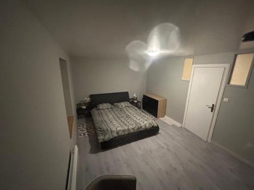 - une petite chambre avec un lit et une porte dans l'établissement Bornel, à Saint-Martin-des-Fontaines