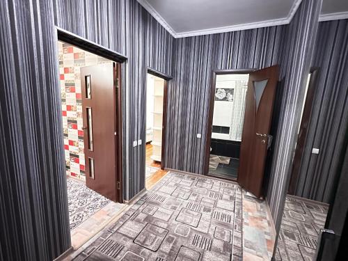 an empty room with a door and a hallway at Cozy apartment in the city center in Bishkek