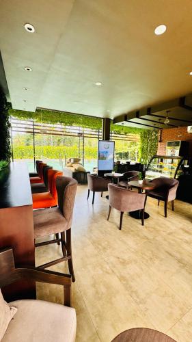 a living room with many chairs and tables at MACA Canterbury Apartment in Gonapola