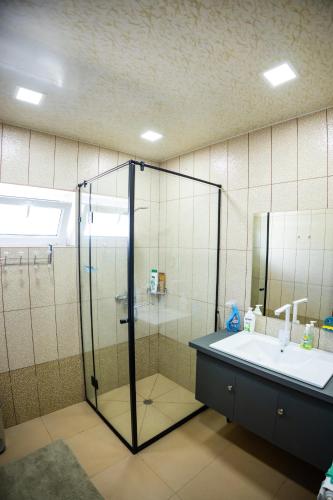 a bathroom with a glass shower and a sink at Lily's Guest House in Shahumyan