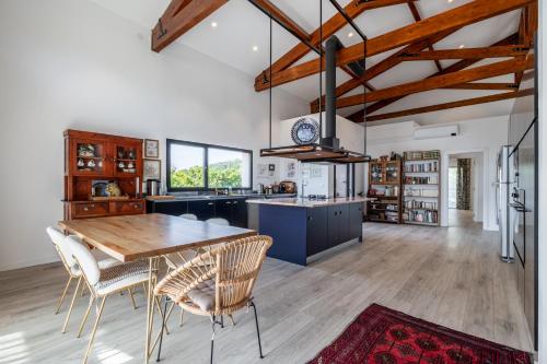 a large kitchen with a wooden table and chairs at Villa Nour in Arrabal