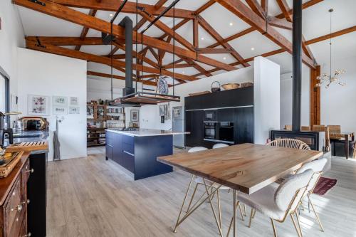 a large kitchen with a wooden table and chairs at Villa Nour in Arrabal