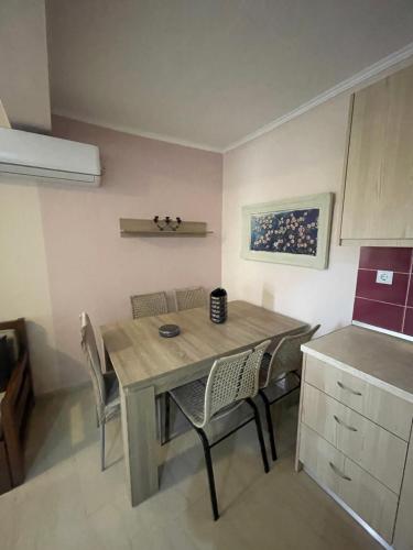 a dining room table and chairs in a kitchen at Anastelia Apartments - 1 in Olympiada