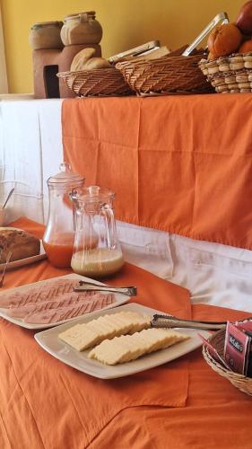 a table with a plate of food and a glass jar of cheese at kuntur inn hotel in Puno
