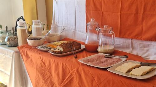 a table with food on an orange table cloth at kuntur inn hotel in Puno