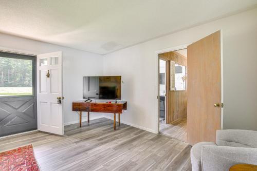 a living room with a table and a kitchen at Water-View Home in the Berkshires in Sheffield