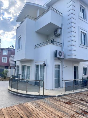 a white building with a ramp in front of it at Happy Land Belek in Belek